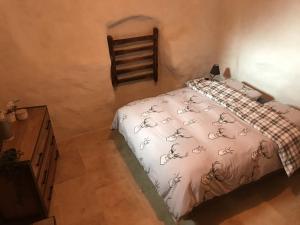 a bedroom with a bed with a white comforter at Maison Carail in Névache