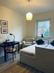 a bedroom with a bed and a table and a chair at Mulberry House in Gdańsk +47 photos