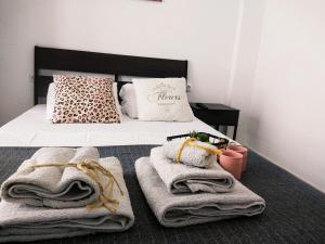 a bedroom with a bed with towels on it at Las Hermanas for 2 in Perea