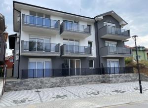 an apartment building with balconies on a street at Apartmani Royal in Veliko Gradište