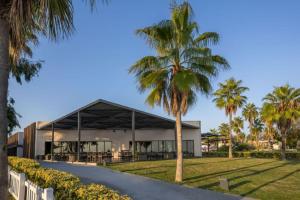 a palm tree in front of a building at Paloma Orenda in Side