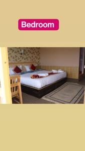 a bedroom with a bed with avertisement for at The hidden heaven cottage pangong merak in Meruk