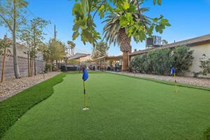 a golf course with two putts on a green at Beautiful home with spa and golf in Las Vegas