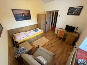 a small room with a bed and a desk at Pension u Svateho Jana in Hradec Králové