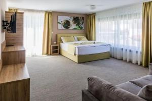 a bedroom with a bed and a couch at EnDi Rooms in Ljubljana