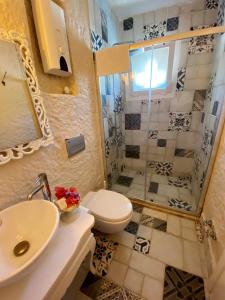 a bathroom with a toilet and a sink and a shower at Naz Konak Alaçatı in Alacati