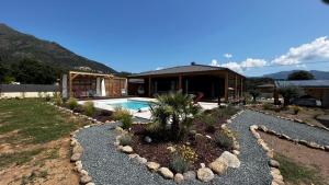 a backyard with a pool and a house at Villas Vallée d'ASCO in Moltifao