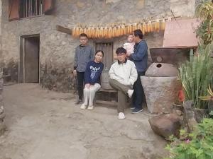 a group of people standing in front of a house at Trieu Hoan homestay in Cao Bằng