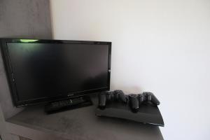 a flat screen tv sitting on top of a table at Ferienwohnung am Bärenstein in Bärenstein +20 photos