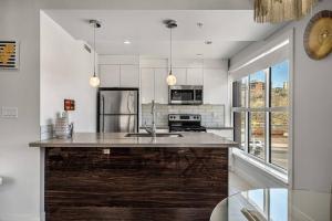 a kitchen with a large island in the middle at BowRiver view downtown 2 bedroom Downtown Calgary in Calgary