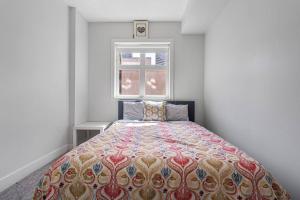 a bed in a room with a window at BowRiver view downtown 2 bedroom Downtown Calgary in Calgary