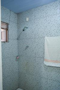 a bathroom with a shower with a tiled wall at Casa Mirante da Ilha in Arez