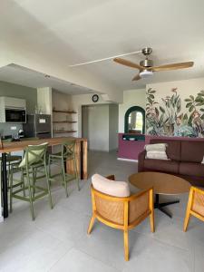 a living room with a couch and a table at Villa Diamant Bleu in Le Diamant