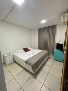 a bedroom with a large bed and a tiled floor at Ap Guanabara-Liberdade-Pertinho de Tudo-Central in Porto Velho