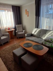 a living room with a couch and a table at Willa Marysieńka in Zakopane