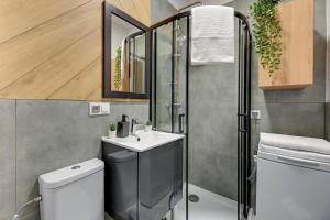 a bathroom with a toilet and a sink and a shower at Gdynia Stacja 24/7 in Gdynia