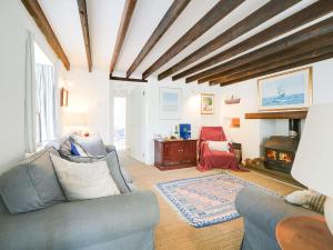 a living room with a couch and a fireplace at Trecarian in Port Isaac