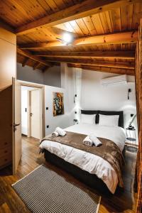 a bedroom with a large bed and wooden ceilings at KONHOUSE στο ιστορικό κέντρο in Ioannina