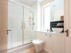 a bathroom with a shower and a toilet and a sink at Deerside, Tobermory in Tobermory