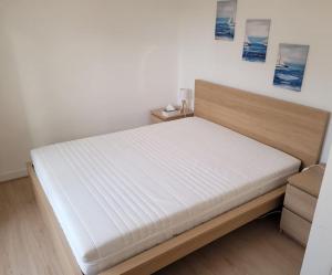 a bed in a room with a white mattress at Côté Mer - Les Gîtes de la Côte d'Amour in Le Croisic