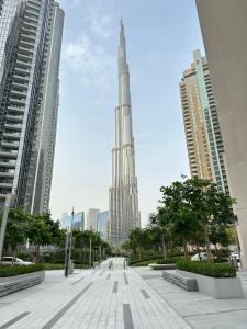 a view of a city with a tall building at 2 Bedrooms Apartment Burj khalifa and fountain view in Dubai