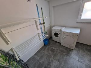 a laundry room with a washing machine and a washer at Velo Invest in Koło