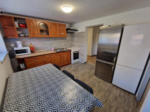 a kitchen with a refrigerator and a table in it at Velo Invest in Koło