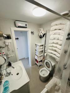 a bathroom with a sink and a toilet and towels at Peaceful Flat Menorca Sea And Wifi in Son Parc