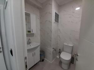 a white bathroom with a toilet and a sink at Choras Butik Otel in Şarköy +23 photos