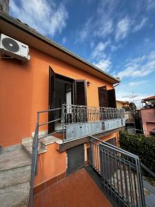 a balcony of a house with an open door at Casa Francesca in Nicolosi