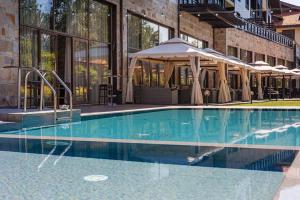 a swimming pool in front of a building at TERRA KOMPLEX D3 - Private apartment - Golf, Skiing & SPA in Razlog