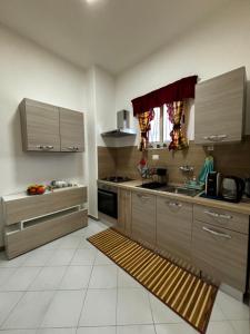 a kitchen with wooden cabinets and a stove top oven at Casa Francesca in Nicolosi