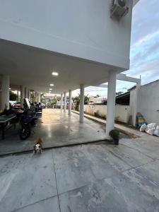 a dog is laying on the floor of a building at Pousada Tamatoa Suítes in Florianópolis