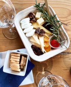 a plate of cheese and crackers on a table at En Suite Flora in Dripping Springs