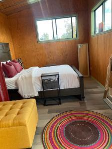 a bedroom with a bed and a window and a rug at En Suite Flora in Dripping Springs