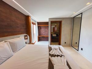 a bedroom with a bed and a brick wall at Kamai Lodge Icaraí in Icaraí