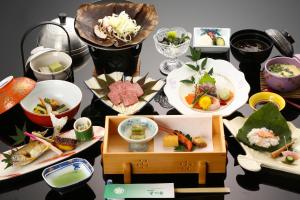 a table topped with plates of food and bowls at Bosenkan in Gero