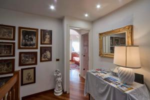 a room with a table with a lamp and a mirror at tosca house 2 in Varenna