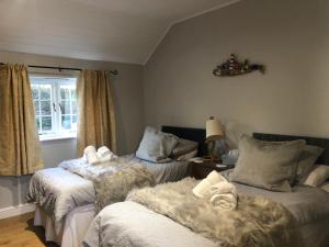 a bedroom with two beds with towels on them at the old rectory cottage in Pwllheli