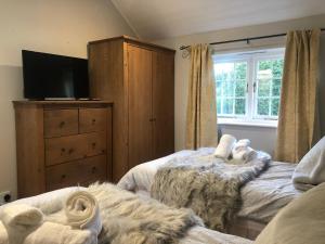 a bedroom with two beds with stuffed animals on them at the old rectory cottage in Pwllheli