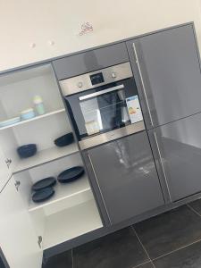 a refrigerator in a kitchen with blue dishes on shelves at Furnished house of Véranda groupe in Niamey