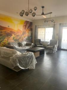 a living room with a painting on the wall at Furnished house of Véranda groupe in Niamey