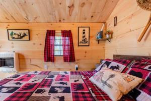 a bedroom with a bed in a log cabin at Shadow Hills farm in Fort Edward