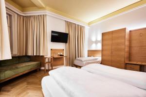 Postel nebo postele na pokoji v ubytování Hotel Jarolim