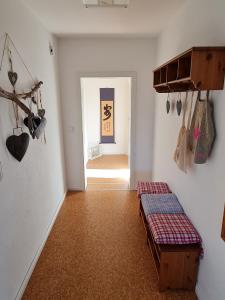 a room with a bench and a hallway with a door at Ferienwohnung Wiesenblick in Illingen