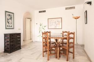 a dining room with a table and two chairs at Frontline Benalmadena Marina Apartment in Benalmádena