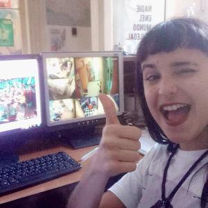 a young boy giving a thumbs up in front of a computer at Montevideo Port Hostel in Montevideo