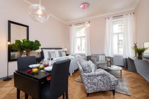 a living room with a bed and a table and chairs at Garden Suites Residence by TKC in Prague