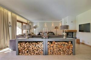 a living room with a pile of fire wood at Spacious, Garden Level, Cable Car 2 Min Walk in Champéry