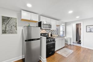 a kitchen with a stainless steel refrigerator and a stove at Whimsical three in Bayonne